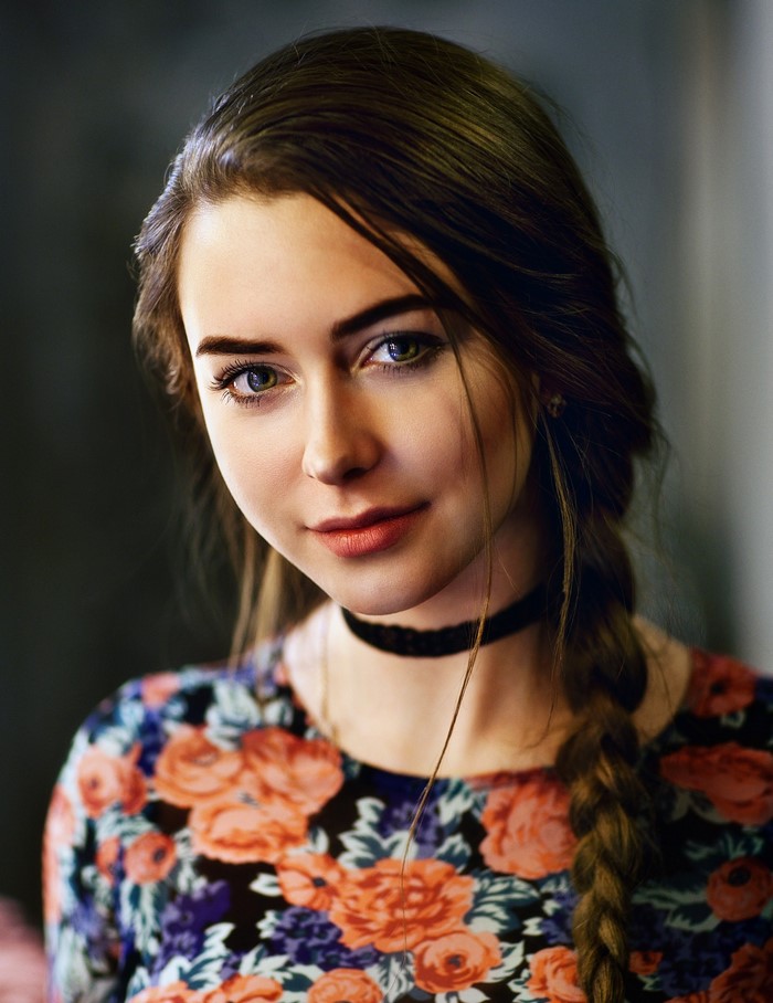 Portrait of a young woman with brown hair and a floral top