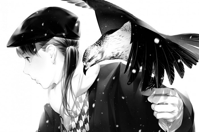 Girl with hawk on shoulder in snow