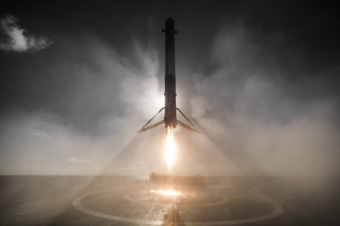 SpaceX Falcon 9 rocket landing at night