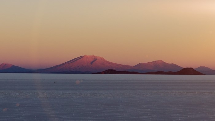 Mountains at Sunset over a Calm Body of Water