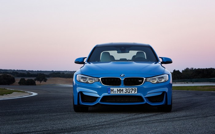 Blue BMW M4 Coupe on a Race Track