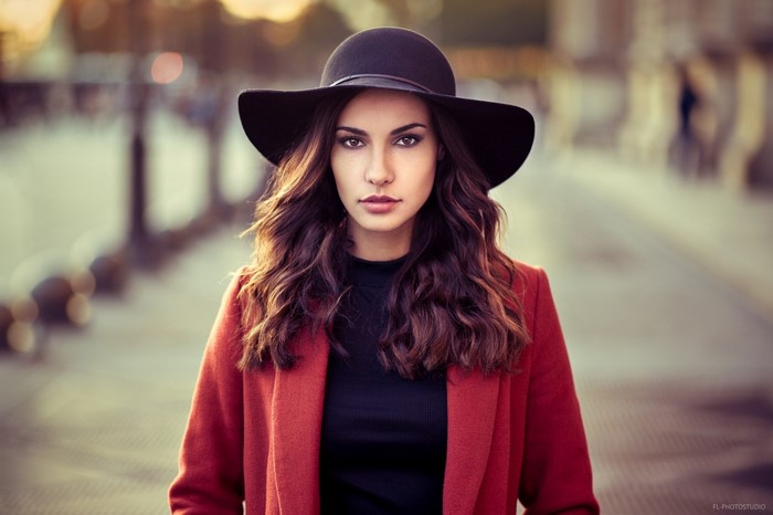 Woman wearing a red coat and black hat