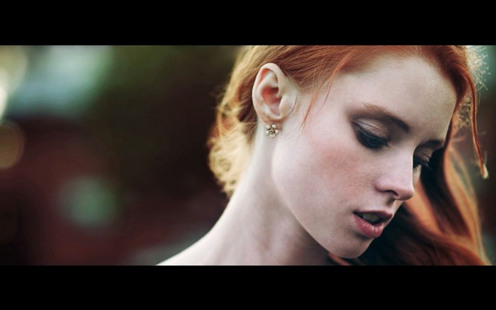 Redhead woman with makeup and earring