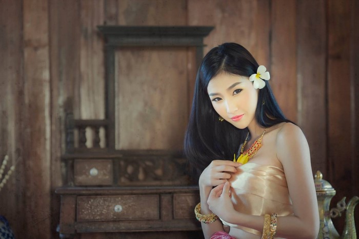 Woman in traditional Thai dress with flower in hair