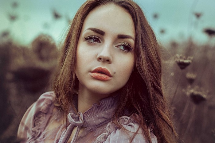 Woman with long brown hair in a field