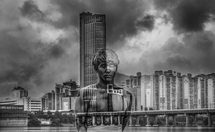 Monochrome double exposure of a man and Seoul cityscape