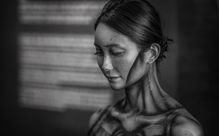 Monochrome portrait of a woman with artistic body paint