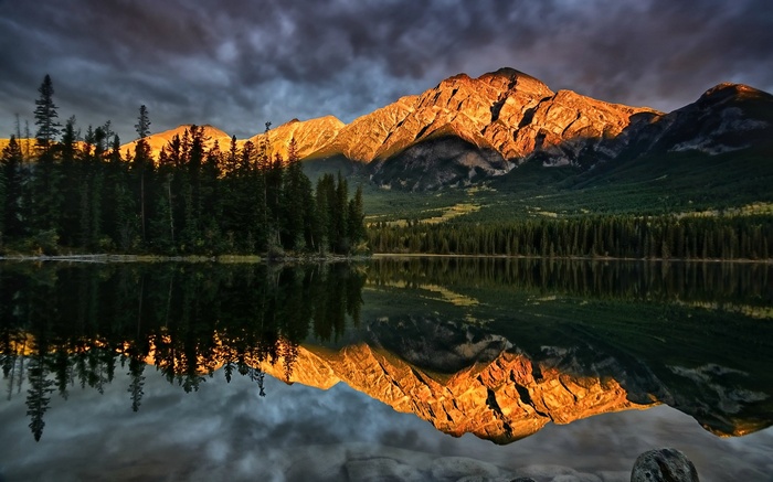 Mountain range reflected in a lake at sunset