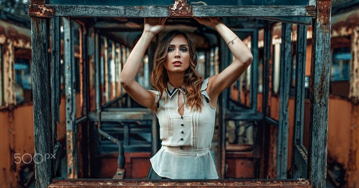 Woman posing in abandoned tram