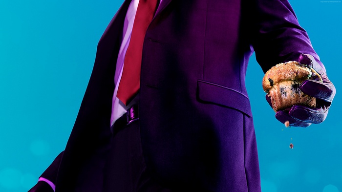 Agent 47 from Hitman 2 holding a muffin