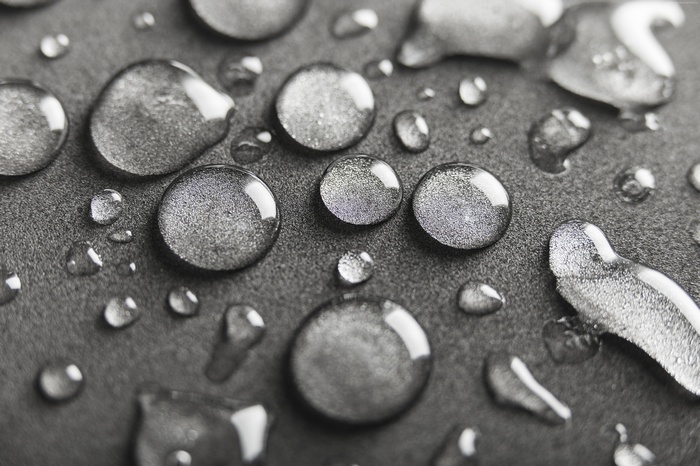 Macro view of water drops on a dark surface