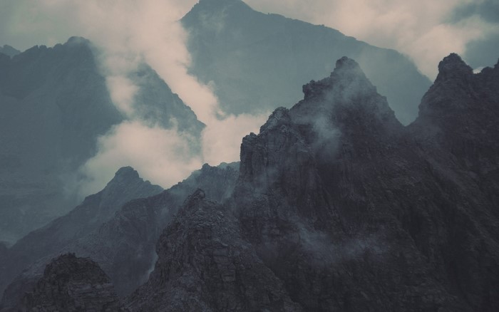 Misty mountain range with jagged peaks