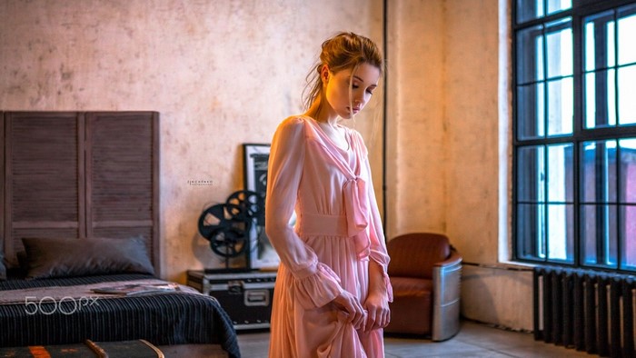 Woman in Elegant Pink Dress in Cozy Room