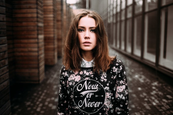 Young Woman in Floral Sweater with Intense Gaze
