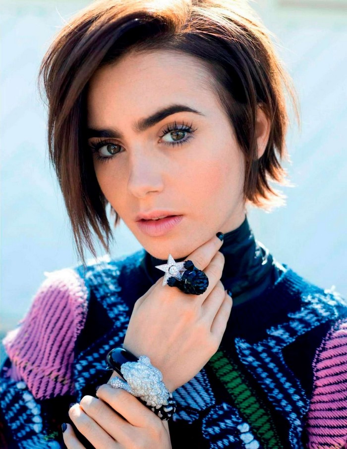Lily Collins portrait with rings and patterned sweater
