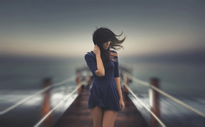 Woman in blue dress on a pier