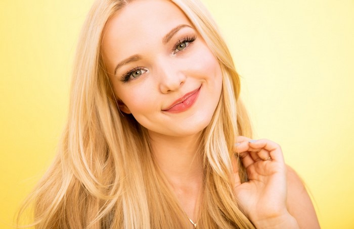 Dove Cameron portrait with blonde hair and dimples