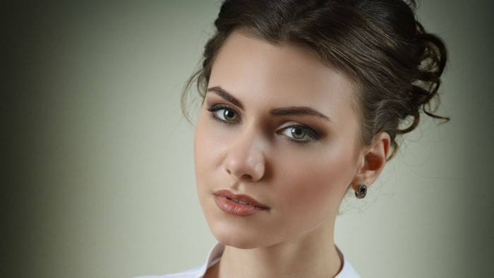 Woman with brown hair and makeup, close-up portrait