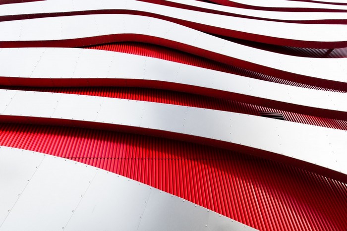 Modern architecture with red and white wavy facade