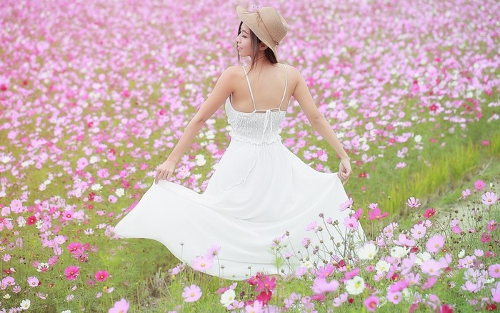 Woman in White Dress in a Flower Field