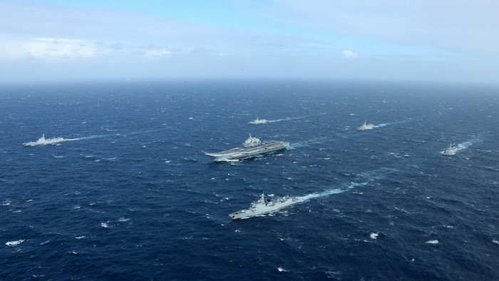Aircraft carrier and escort ships at sea