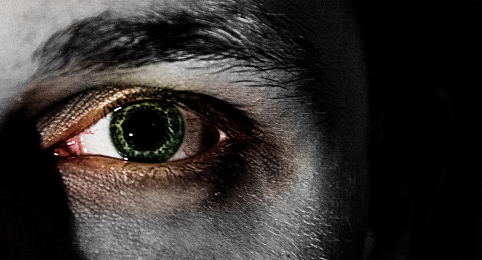Close-up of a human eye with green iris