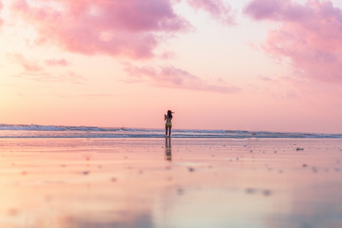 Girl on a beach at sunset