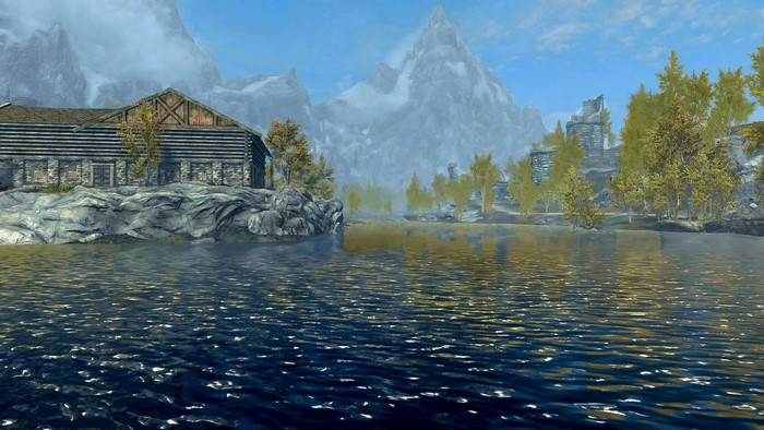Log cabin by a lake with mountains in Skyrim