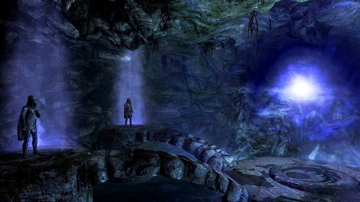 Two figures in a dark, glowing cave in The Elder Scrolls V Skyrim