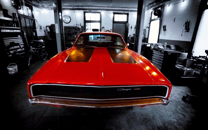 Red Dodge Charger in a garage