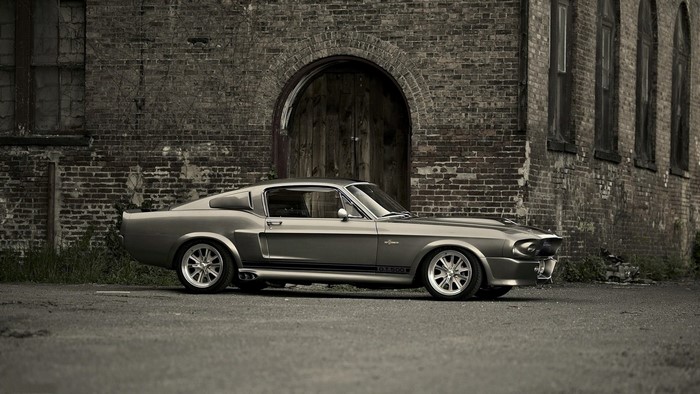 Classic Ford Shelby GT500 Mustang parked by brick building