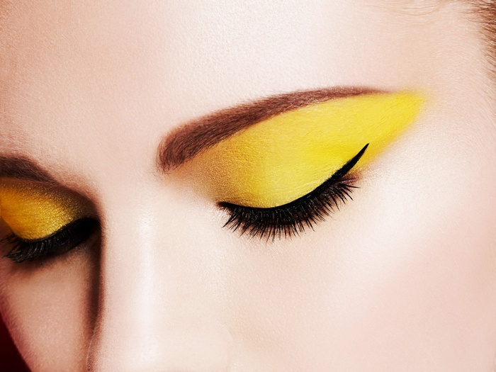 Close-up of woman's eyes with yellow eyeshadow