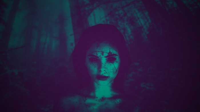 Creepy woman with dark eyes in a forest