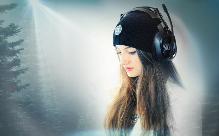 Woman wearing headphones and beanie in a foggy forest
