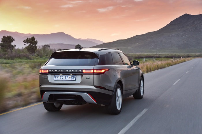 Range Rover Velar S driving on a road at sunset