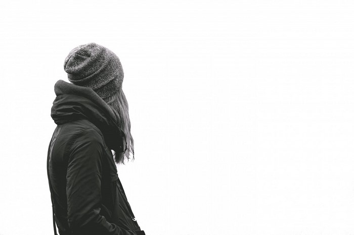 Woman wearing a beanie and jacket outdoors