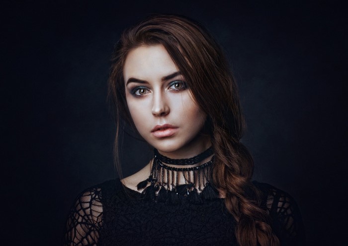 Woman with braided brown hair and black choker