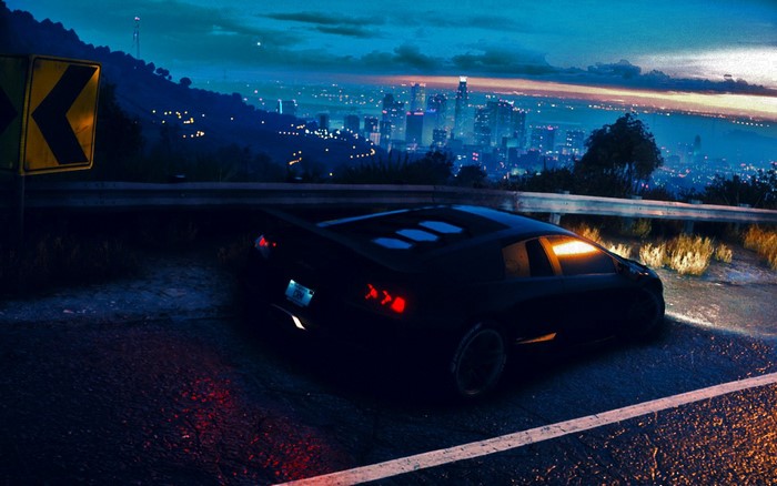 Black Lamborghini Aventador on a winding road at night