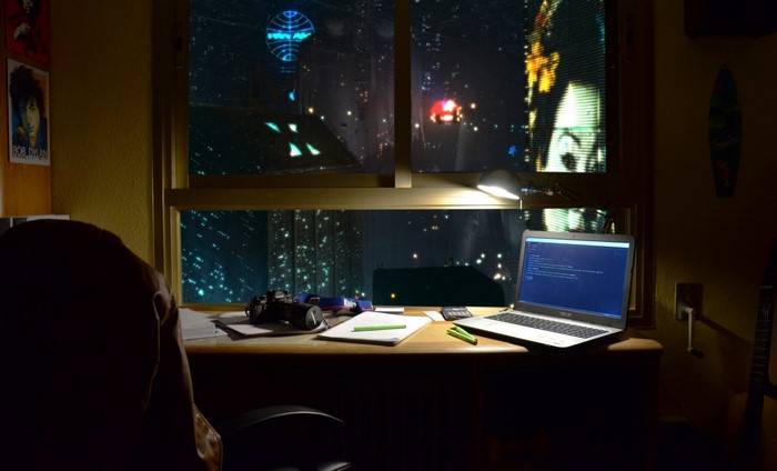 Cyberpunk room with laptop and city view