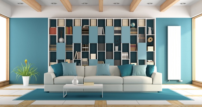 Modern living room with blue walls and white bookshelf