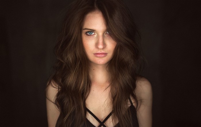 Woman with long brown hair and blue eyes