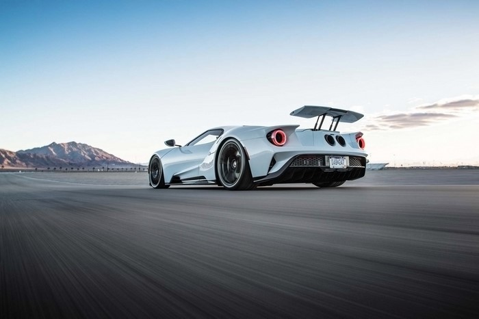 White Ford GT sports car driving on a road