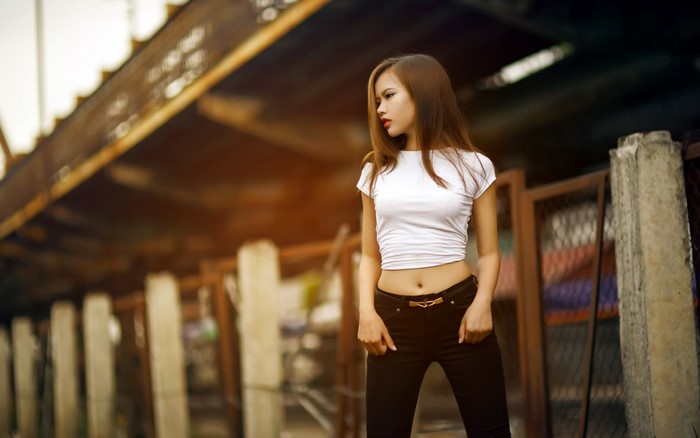 Asian woman in white crop top and black pants outdoors