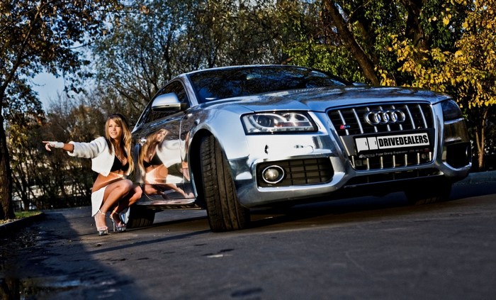 Woman pointing at a chrome Audi S5