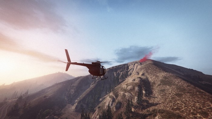 Helicopter flying near a mountain with red smoke