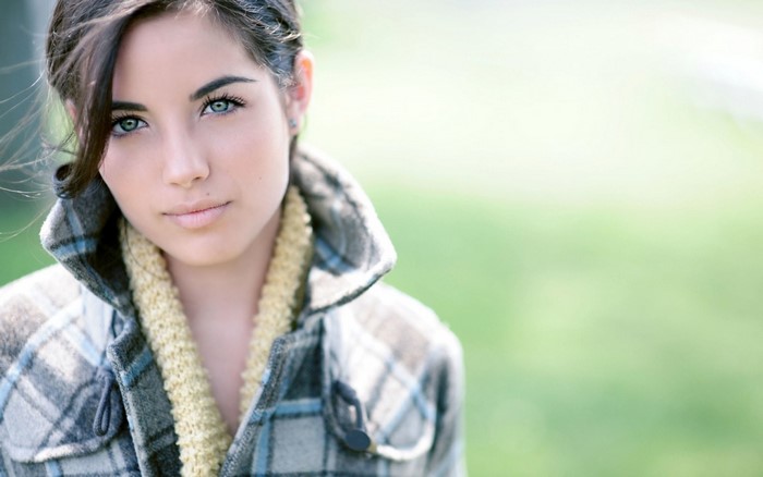 Woman with blue eyes wearing a plaid coat