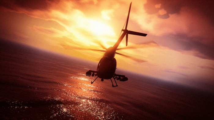 Helicopter flying over the ocean at sunset