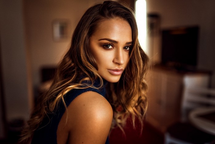 Woman with long brown hair posing for a portrait