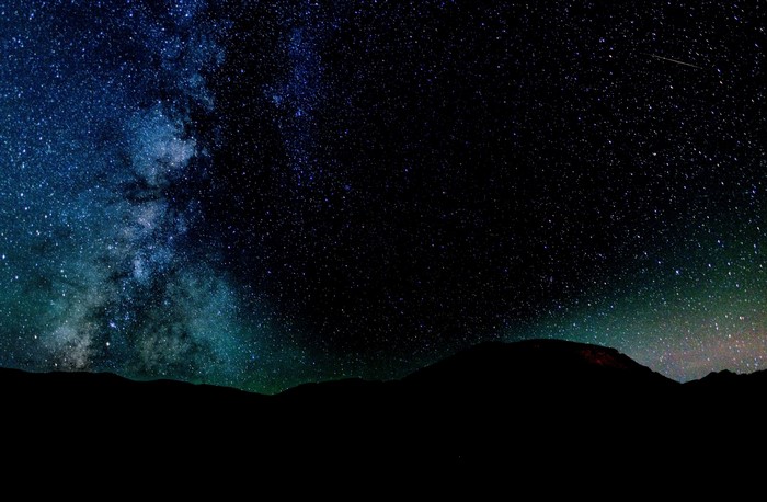 Milky Way galaxy over silhouetted mountains at night