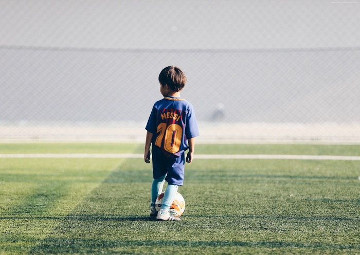 Child in Messi Soccer Jersey on Field